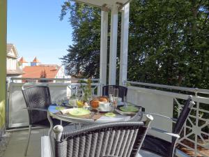 a table on a porch with a meal on it at Zinnowitz, Fewo Sonnendomizil in Zinnowitz