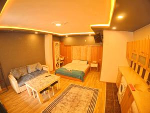 a living room with a couch and a table at Kusva Apart in Uzungol