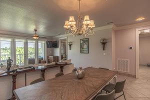 a dining room with a table and chairs and a chandelier at Caddyshack Condo in Big Blackjack Landing