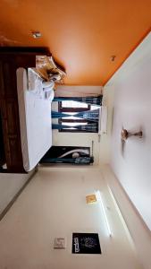 an empty kitchen with an open refrigerator in a room at BENARAS BILLS STAY INN... in Varanasi