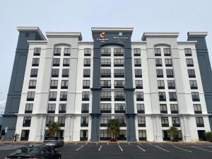 a large white building with a sign on it at MainStay Suites Conover-Hickory in Conover