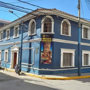 a blue building on the side of a street at PUNO ANDENES Suite in Puno