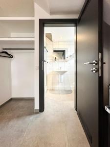 un baño con una puerta que conduce a un lavabo en SI-View Einzelzimmer Zimmer 9, en Siegen