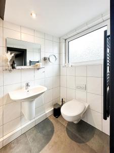 a white bathroom with a sink and a toilet at SI-View Einzelzimmer Zimmer 9 in Siegen