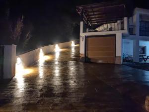 a row of lights on a sidewalk at night at Paraje fuente del pintor in Iznalloz