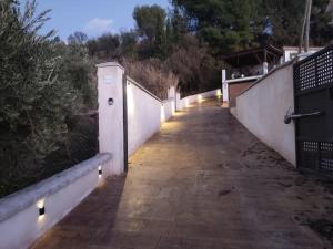 a sidewalk with lights on the side of a fence at Paraje fuente del pintor in Iznalloz