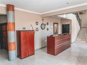 a room with pillars and a cross on the wall at Khutso Boutique Hotel in Hazyview