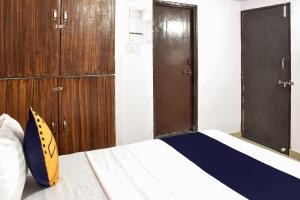 a bedroom with a bed with wooden doors at SPOT ON Hotel Krrish in Durg