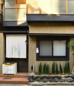 a building with windows and plants in front of it at ＦＬ　ＨＯＵＳＥ浪速・桜畔 in Osaka