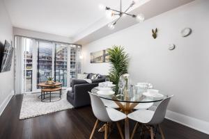 a living room with a table and a couch at DWTN Condo Near CN Tower! w/ Free Parking in Toronto