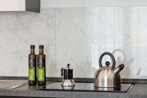 two bottles of wine sitting on a kitchen counter at Case Vacanza Loria in Castelluzzo
