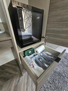 an open drawer in a room with a tv at Home Sweet Home in Ballycastle