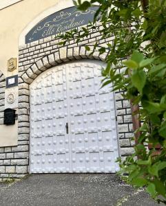 a white garage door in a brick building at Éllő Residence in Veszprém