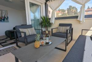 een woonkamer met een tafel en stoelen en een ananas bij Prime Location Penthouse apt with a large terrace in Split