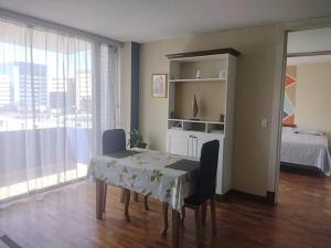 a room with a table and chairs and a bed at Apartamento 505 Cortijo Reforma zona 9 in Guatemala +29 photos