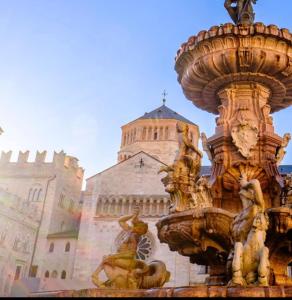 a fountain in front of a castle at Appartamenti ClesioResidenceBuonconsiglio in Trento