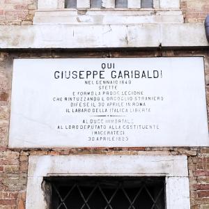 a sign on the side of a building at Garibaldi Guest House in Macerata