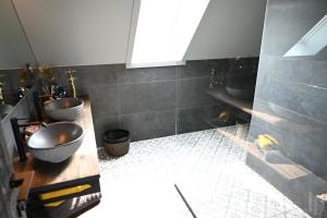 a bathroom with two sinks and a counter with two sinks at SUBSTANTIEL - Luxury Rooms & Wellness Suite in Brunehaut