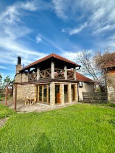 a large brick house with a table in front of it at Etno Selo Krnić in Vladimirci