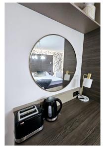 a mirror in a hotel room with a toaster and a bed at Home Sweet Home in Ballycastle