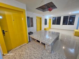a living room with a table and a yellow door at The Ortus Stays -The Sunset Room in Orchha