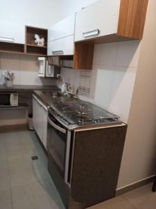 uma cozinha com um fogão e uma bancada em casa com bela vista em Bragança Paulista em Bragança Paulista