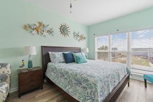 a bedroom with a bed and a window at Key Rest in Oak Island +58 photos