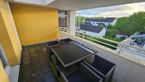 - un balcon avec une table et des chaises dans l'établissement Appartement en duplex agréable à Élancourt, à Élancourt