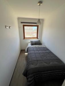a bedroom with two beds and a window at Departamento 2D 2B in Los Ángeles