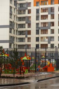 a playground in front of a tall building at Astana arena ЖК Бухар Жырау in Taldykolʼ