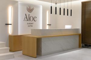 an office with a desk with a sign on the wall at Aloe Elegant Suites in Skala Potamias