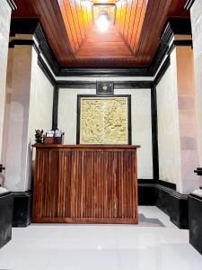 a wooden podium in a room with a picture on the wall at Pala House in Ubud