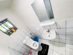 a bathroom with a sink and a toilet and a mirror at Muhazi View Resort in Muhazi