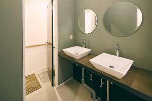 a bathroom with two sinks and a mirror at kagelow Mt.Fuji Hostel Kawaguchiko in Fujikawaguchiko