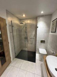 a bathroom with a shower and a toilet and a sink at Tarporley No 7 in Tarporley