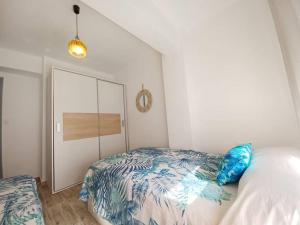 a bedroom with a bed and a dresser in it at Piso Cibeles in Cullera