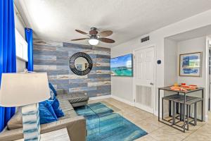 a living room with a couch and a ceiling fan at Luxury Suite| Beach| Fishing| Dock in St. Pete Beach