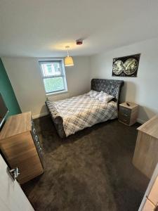 a bedroom with a bed and a window at Cozy 6 Bedroom HMO in Eston