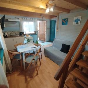 a small living room with a table and a couch at Ośrodek Azyl Mironice in Kłodawa