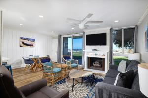 a living room with a couch and a fireplace at Seaside Cottage in Oceanside