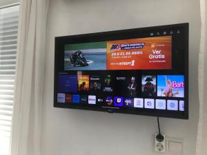 a flat screen tv hanging on a wall at Penthouse Apartment, Cortijo Fruitful HIlls in Málaga