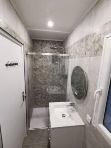a bathroom with a shower and a sink and a mirror at La Tiny de Louis, au milieu des oliviers, avec jolie piscine in Draguignan