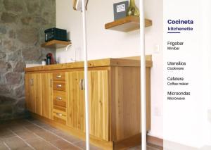 a kitchen with wooden cabinets and a counter top at Cabin Aguacate Natural Getaway Amazing Amenities in Zitácuaro