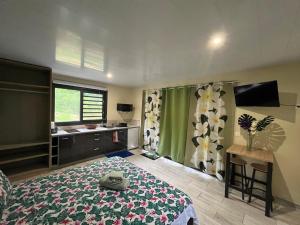 a bedroom with a bed and a desk and a window at Tuna House in Maroe