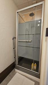 a glass door of a shower in a room at Le Girod #Proche Centre#Confort in Clermont-Ferrand