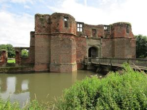 an old castle with a bridge over a river at Wilshere House in Kirby Muxloe