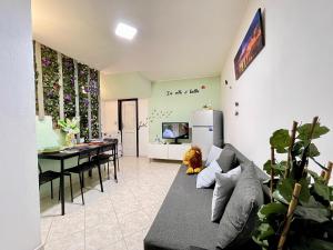 a living room with a couch and a dining room at bilocale 40 mt dal mare 2 piani in Rimini