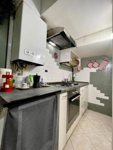 a kitchen with a sink and a dishwasher at bilocale 40 mt dal mare 2 piani in Rimini