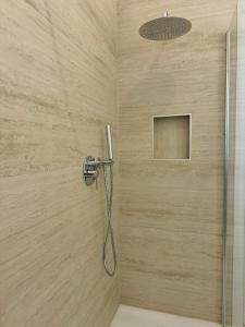 a shower with a shower head in a bathroom at B&B Casa Morgana in Olbia +22 photos