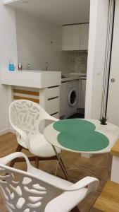 kuchnia ze stołem i krzesłami w kuchni w obiekcie Estúdio mobilado com cozinha na Covilhã w mieście Covilhã
